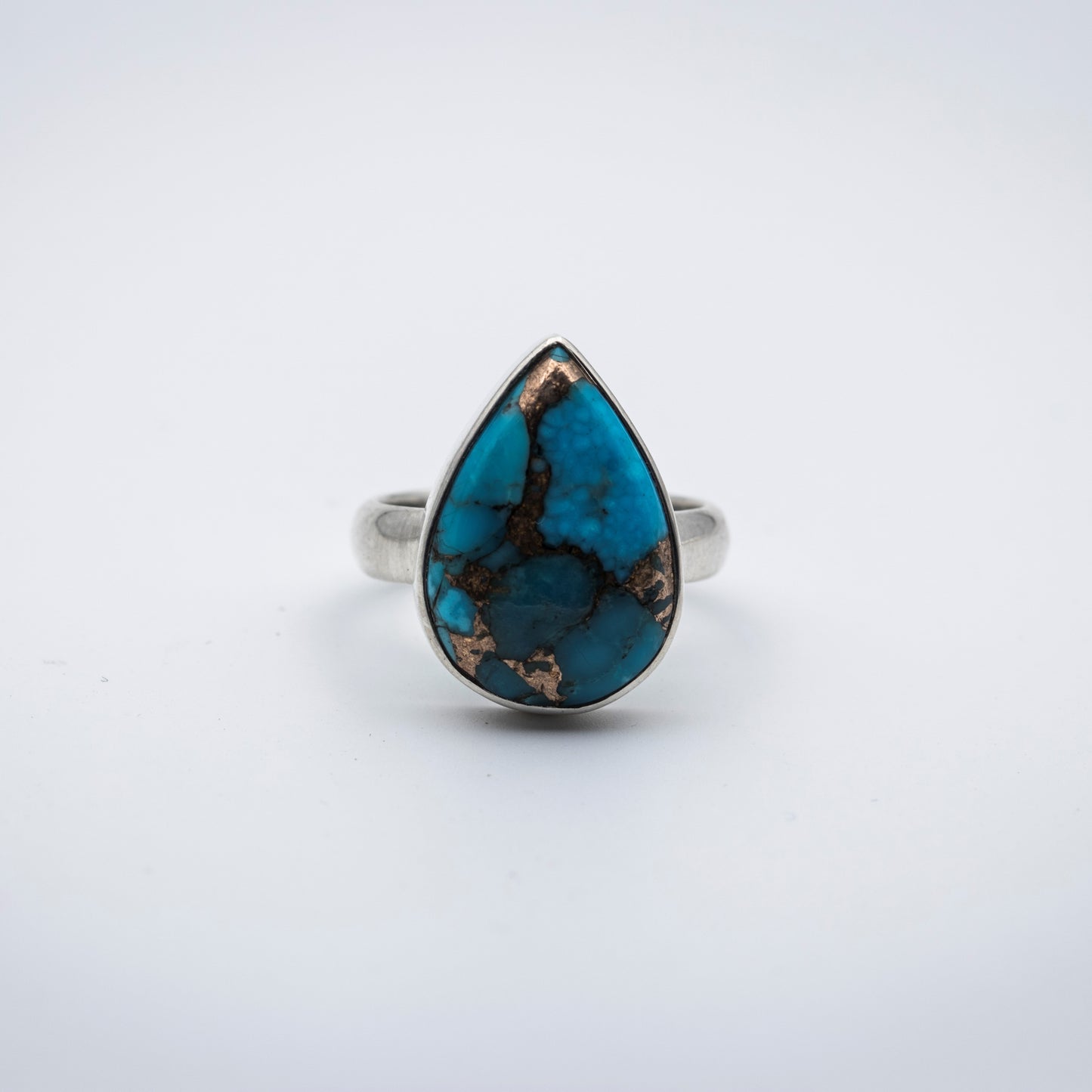 Blue Copper Turquoise Silver Ring on a gray surface