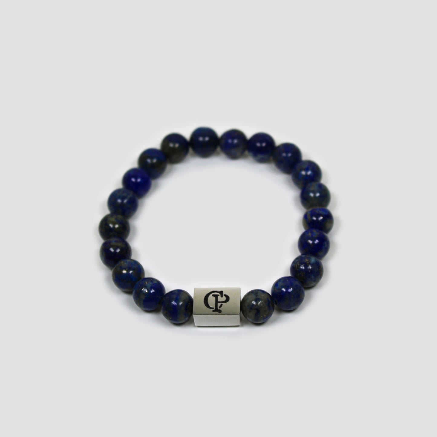 Blue Lapis Lazuli Elastic Silver Bracelet on a gray surface