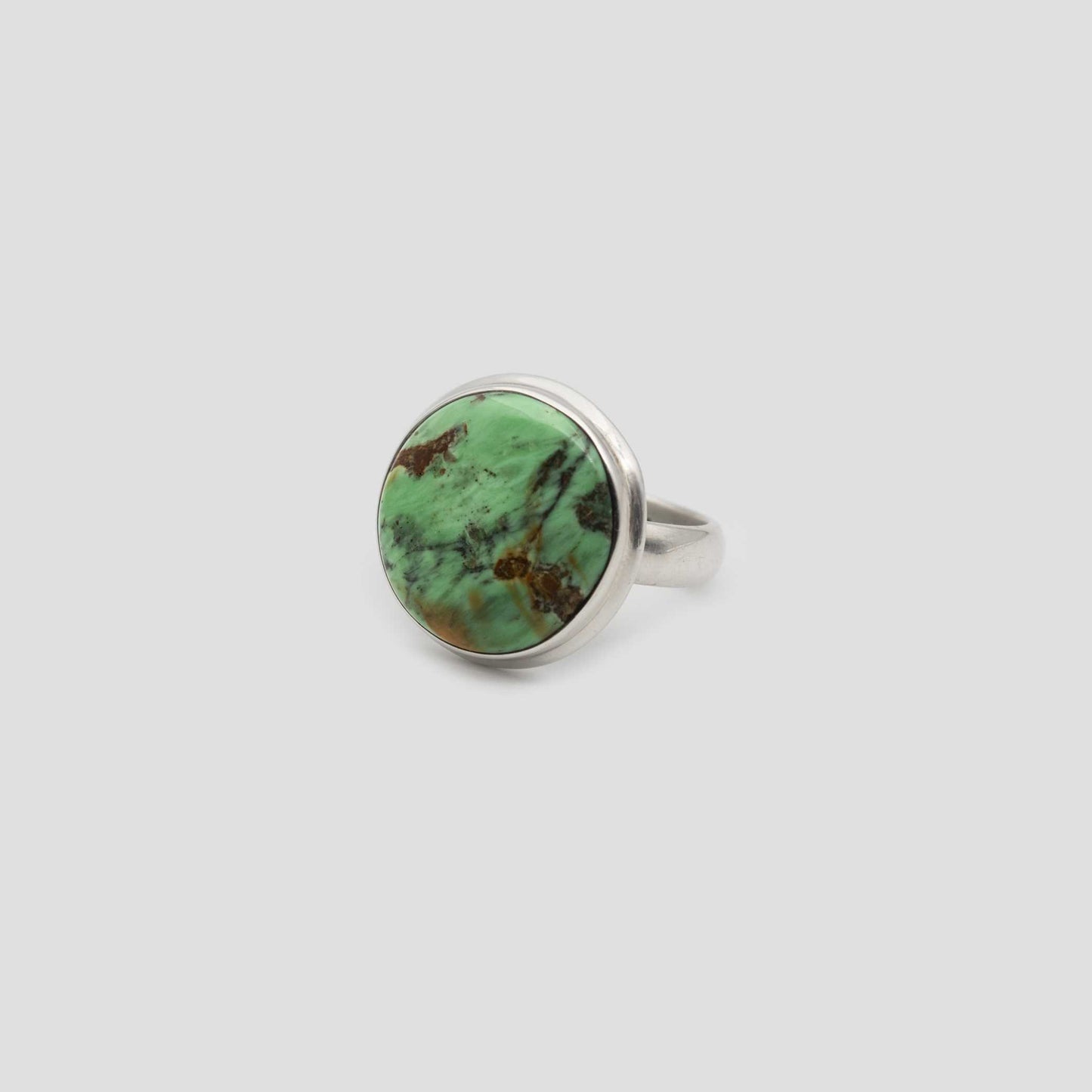 Green Variscite Silver Round Ring on a gray surface