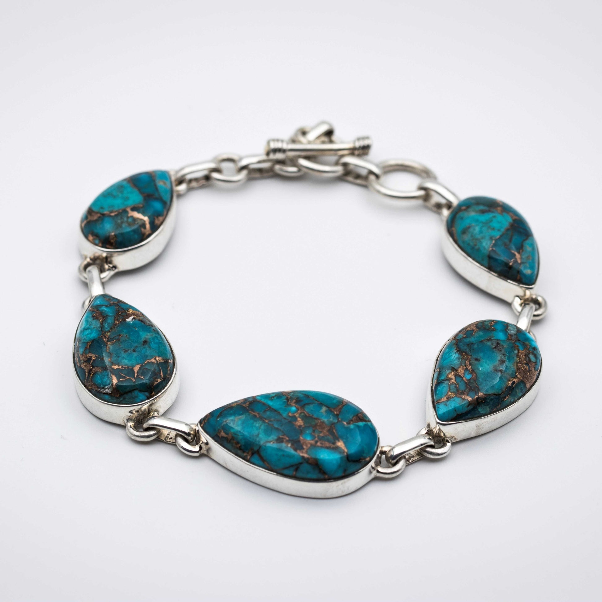 Blue Copper Turquoise Silver Bracelet on a gray surface