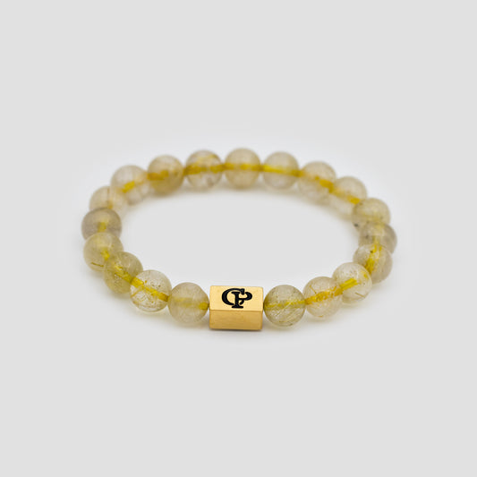 Yellow Golden Rutile Elastic Golden Bracelet on a gray surface