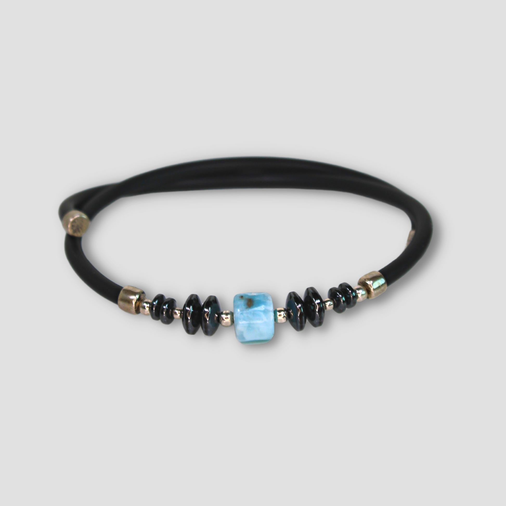 Larimar Hematite Leather Cord Bracelet on a gray surface