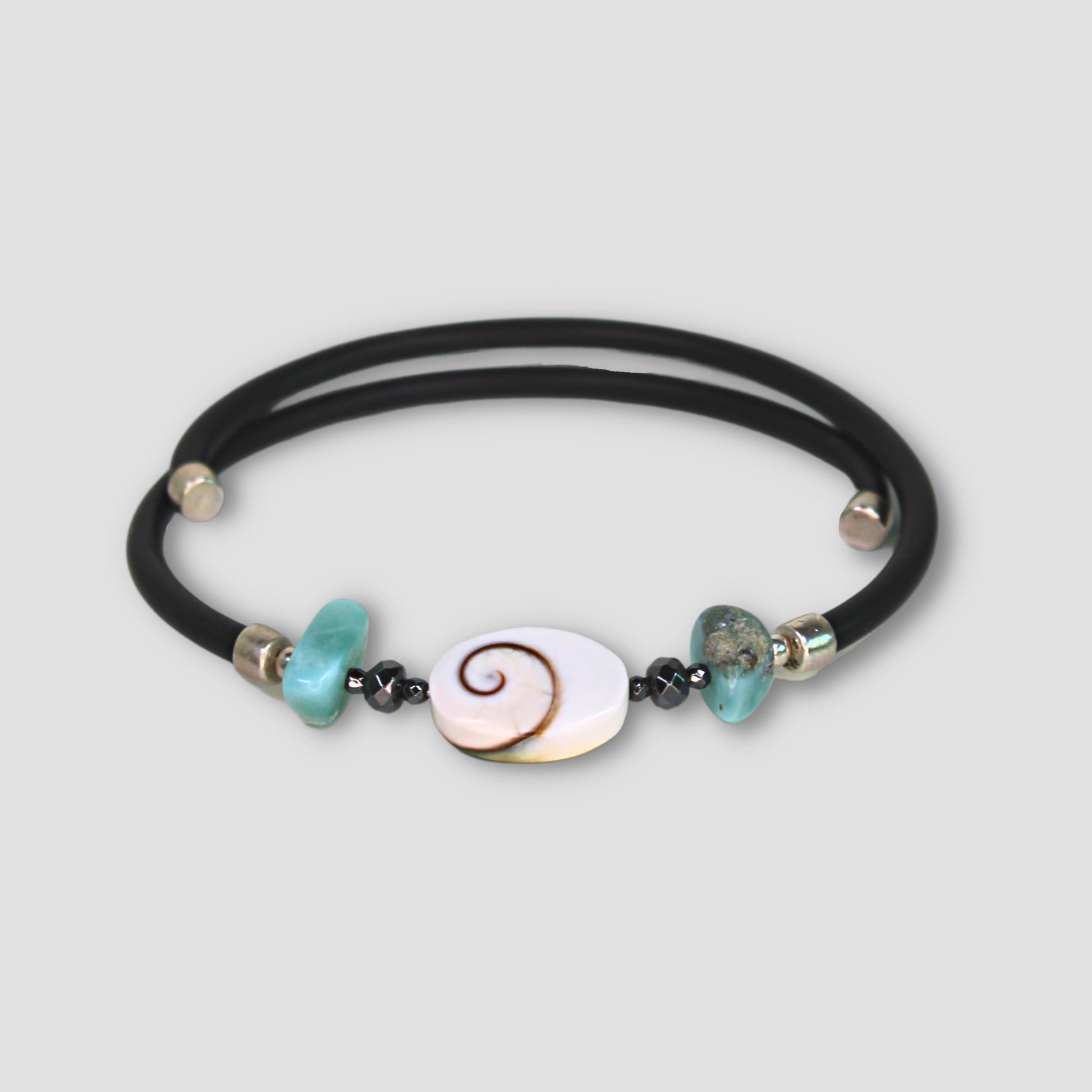 Larimar Hematite Shiva Eye Bracelet on a gray surface