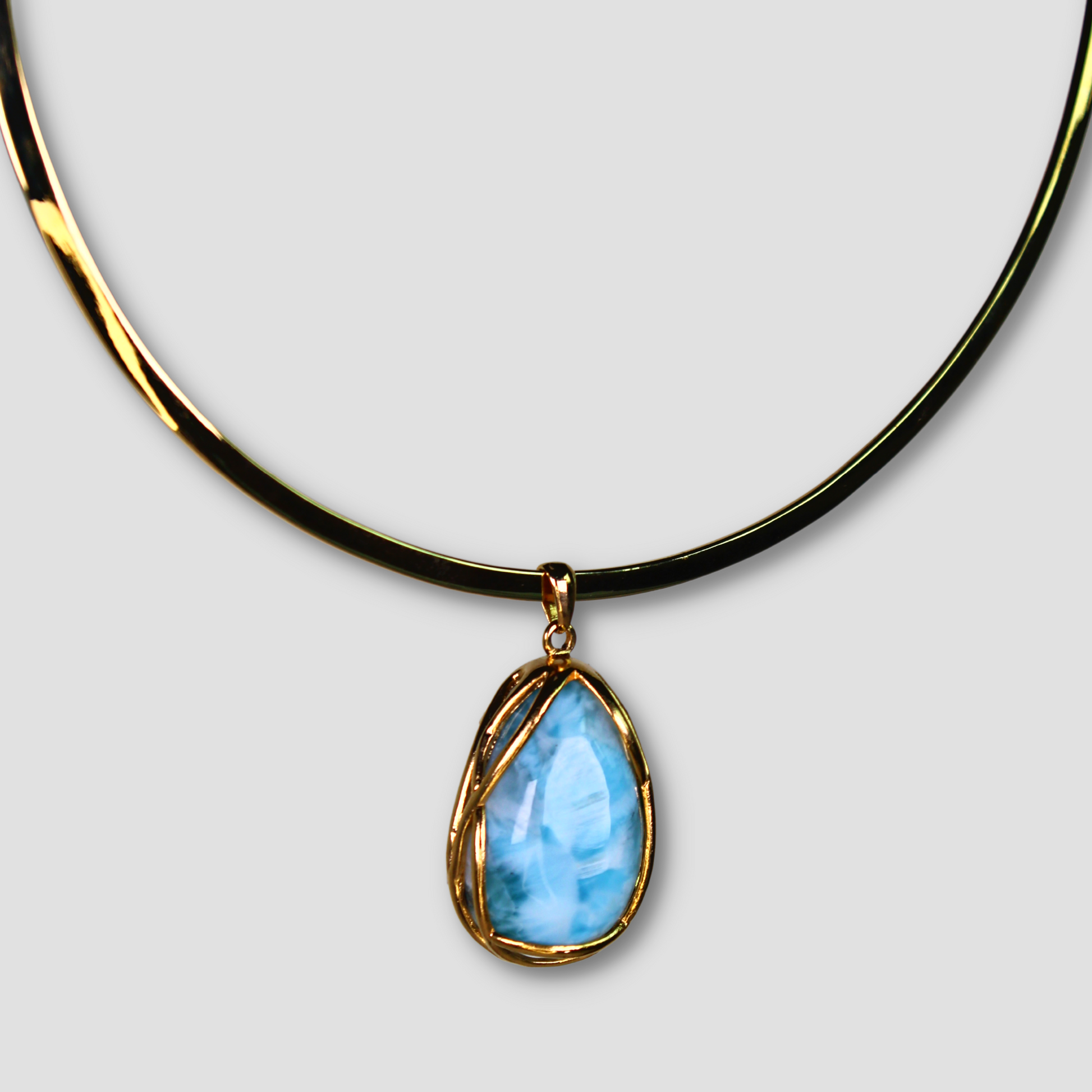 Larimar Gold Plated Necklace on a gray surface