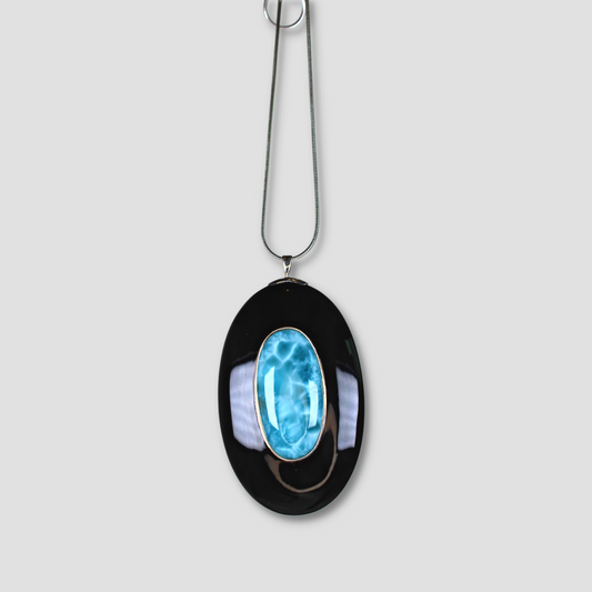 Larimar Oval Pendant on a gray surface
