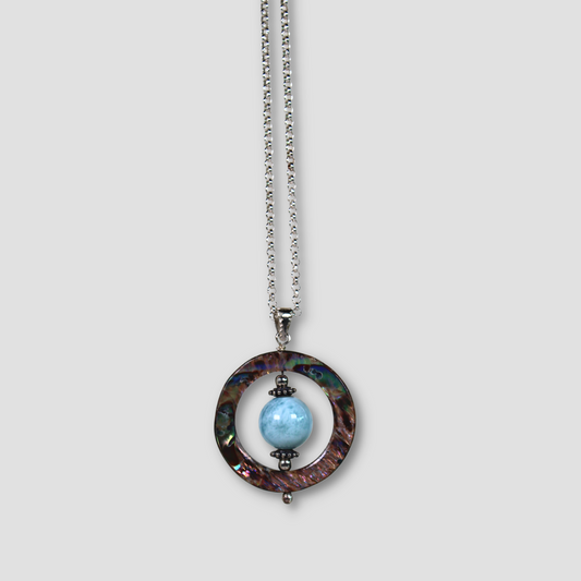 Larimar & Abalone Stability Necklace on a gray surface