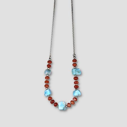 Red and Light Blue Larimar & Carnelian Necklace on a gray surface