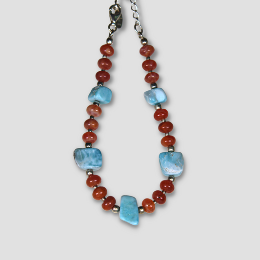 Red and Light Blue Larimar & Carnelian Bracelet on a gray surface