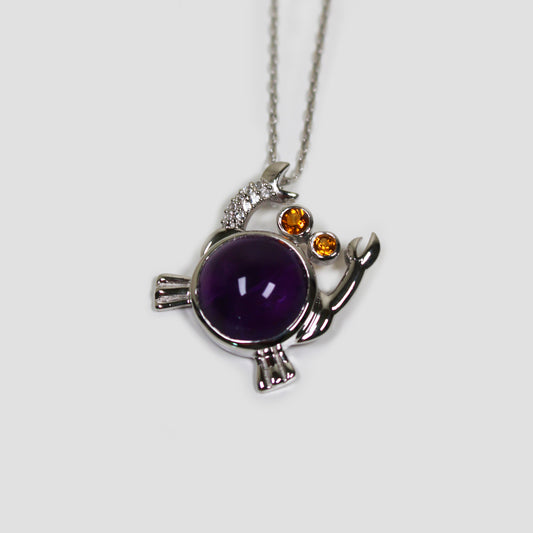 Purple Amethyst Crab with White Topaz Necklace on a gray surface
