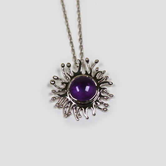 Amethyst Purple Solaire Necklace on a gray surface