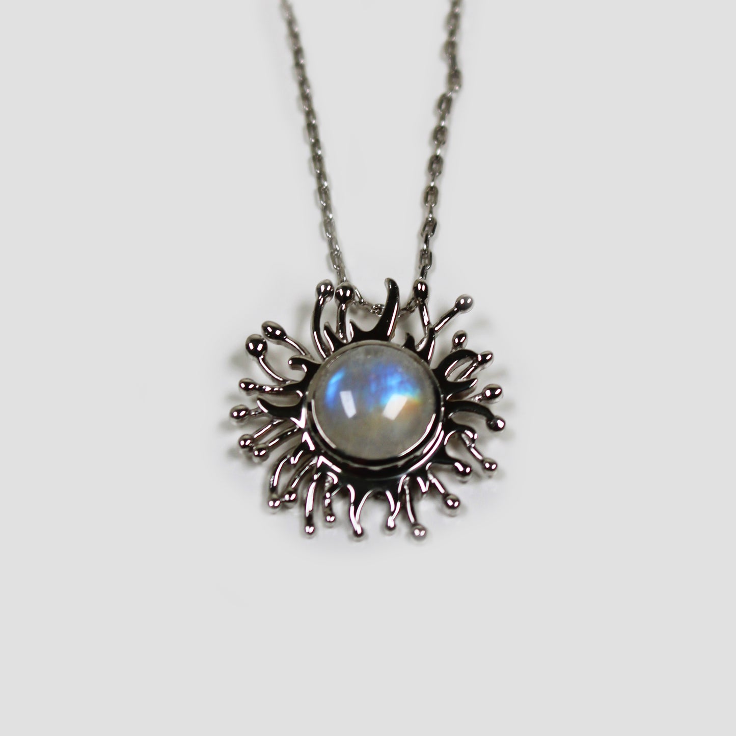 Moonstone Solaire Necklace on a gray surface