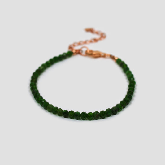 Green Chrome Diopside Faceted Bracelet on a gray surface