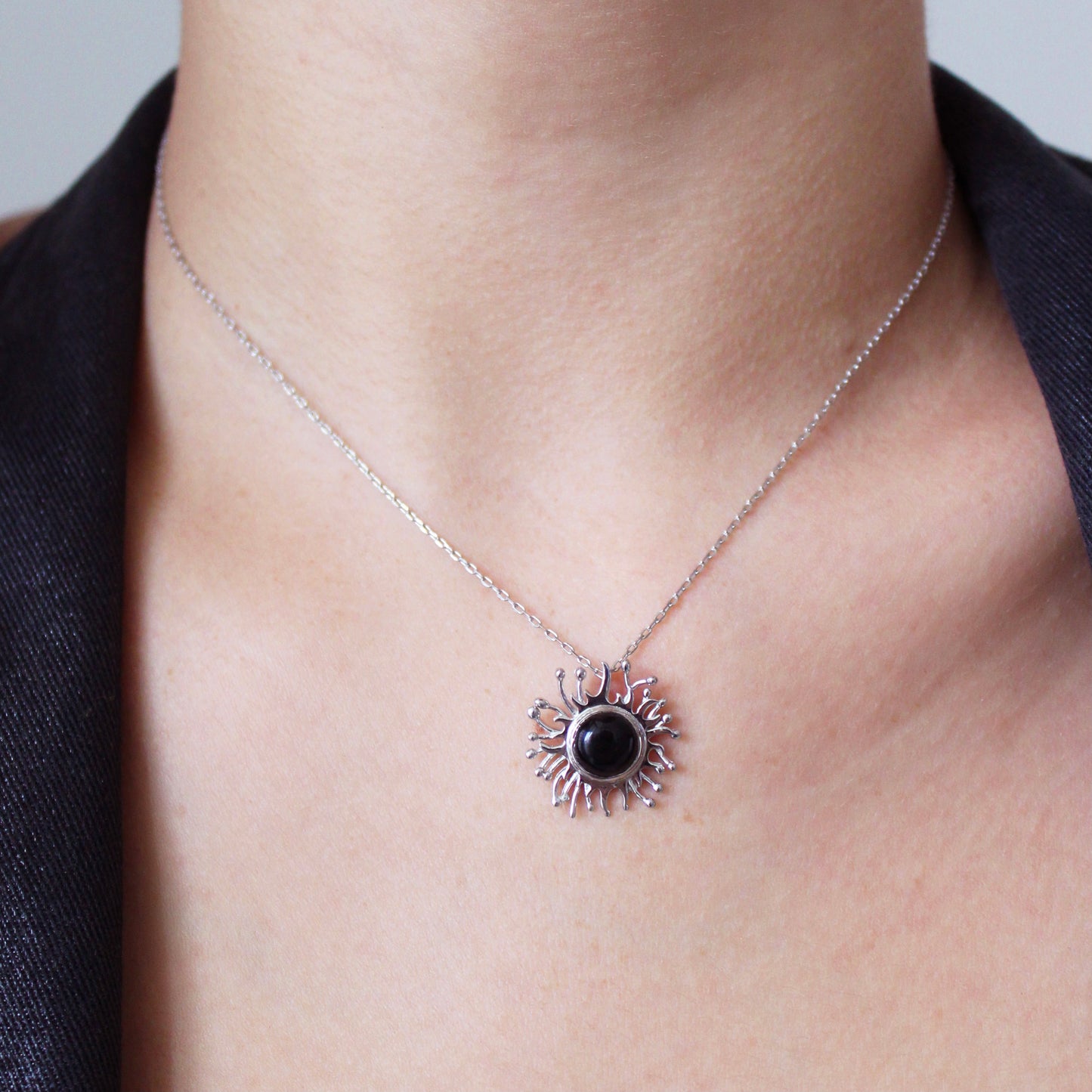 A woman wearing Black Onyx Solaire Necklace 