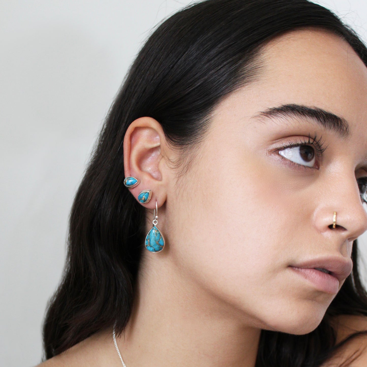 A woman wearing Blue Copper Turquoise Silver Earrings