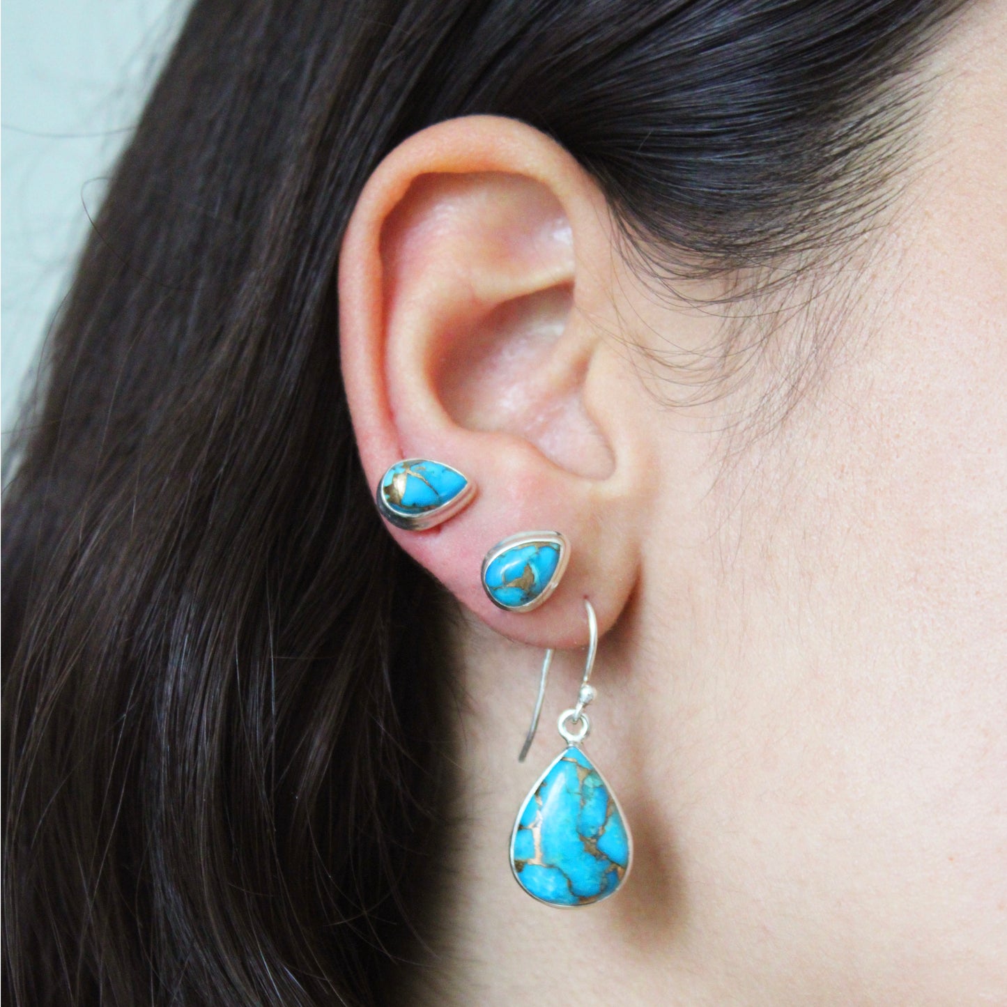 A woman wearing Blue Copper Turquoise Silver Earrings