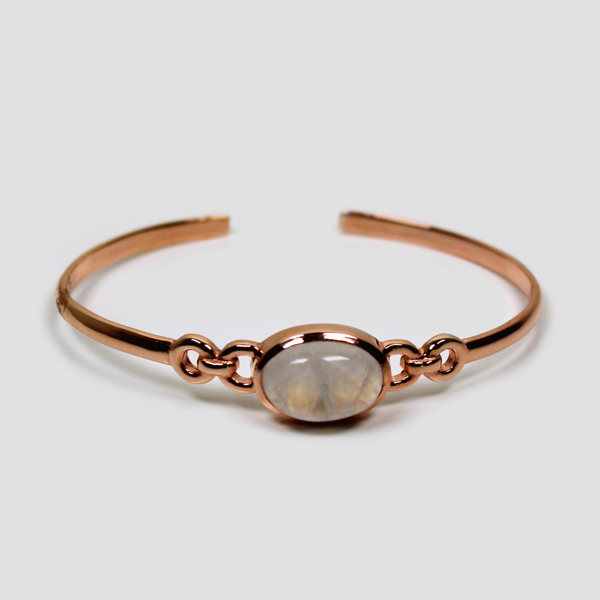 White Moonstone Adjustable Silver Rose Gold Bangle on a gray surface