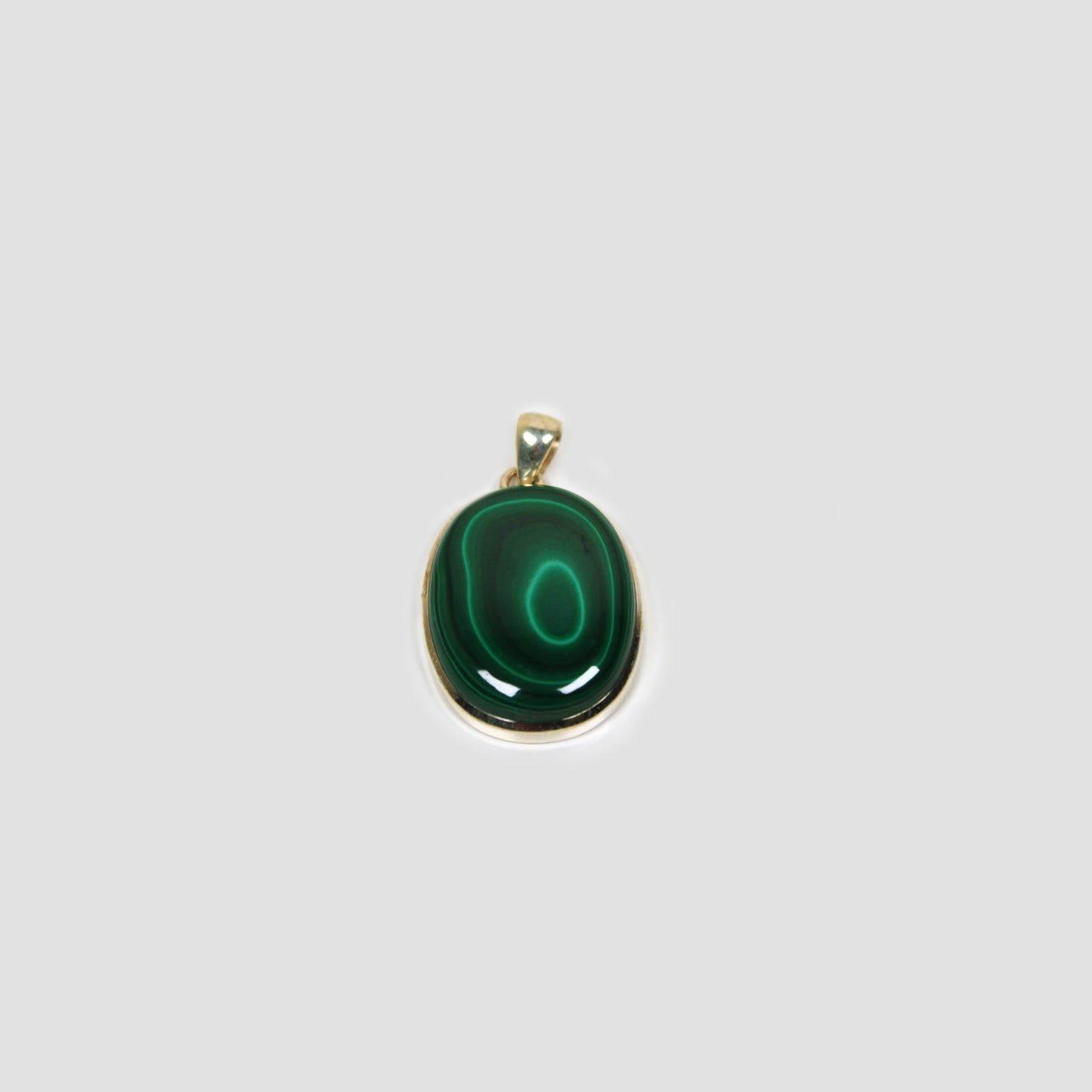 Green Malachite Silver Pendant on a gray surface