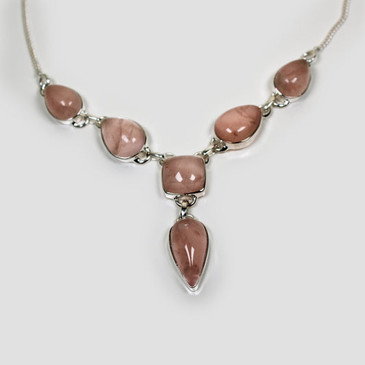 Rose quartz Silver Necklace on a gray surface