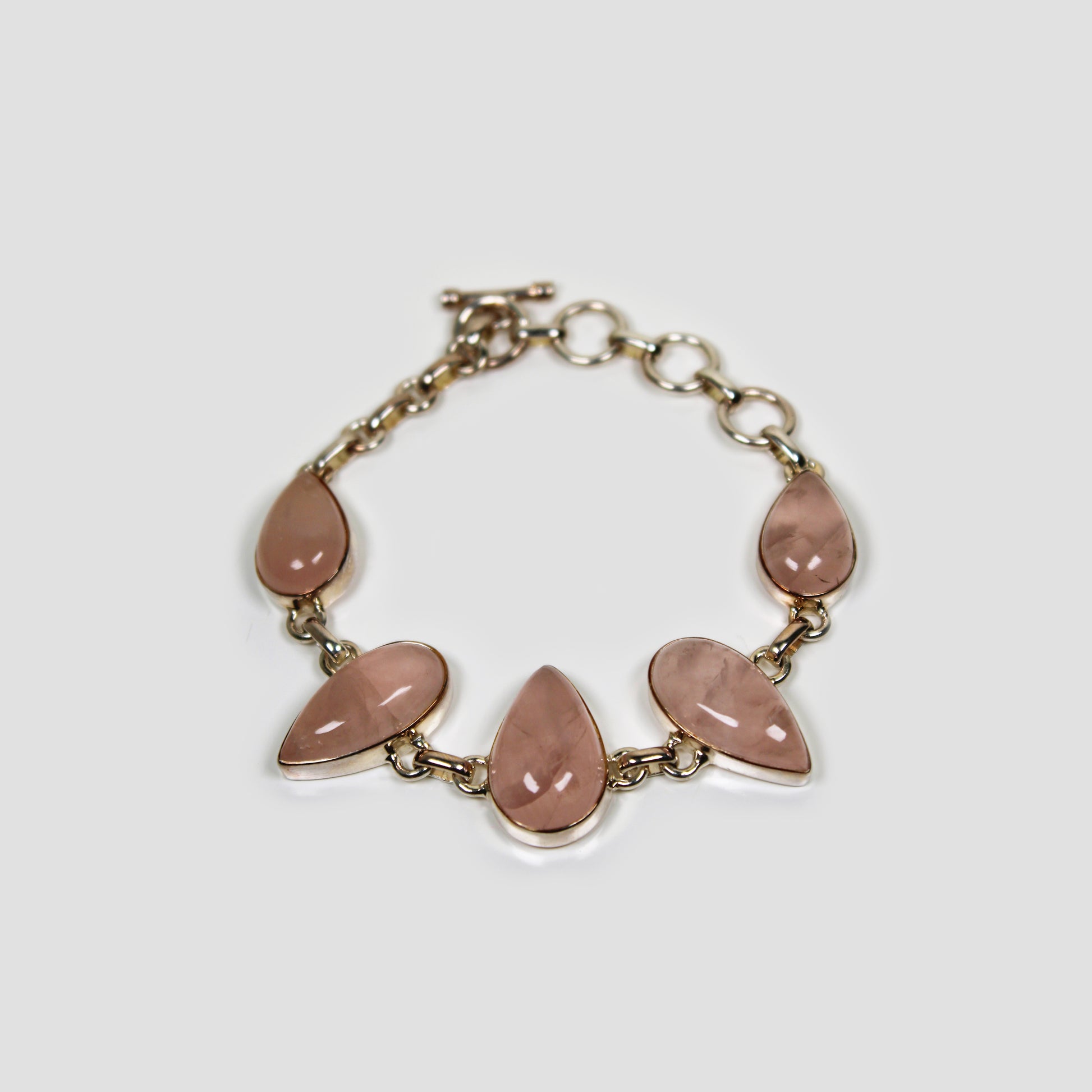 Rose quartz Silver Bracelet on a gray surface