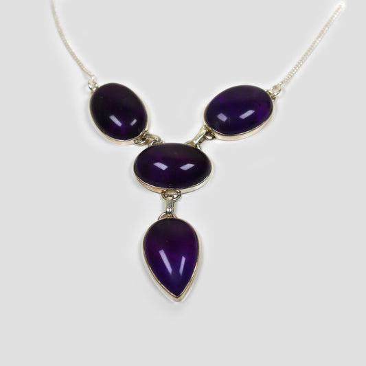 Purple Amethyst Silver Necklace on a gray surface