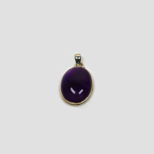 Purple Amethyst Silver Pendant on a gray surface