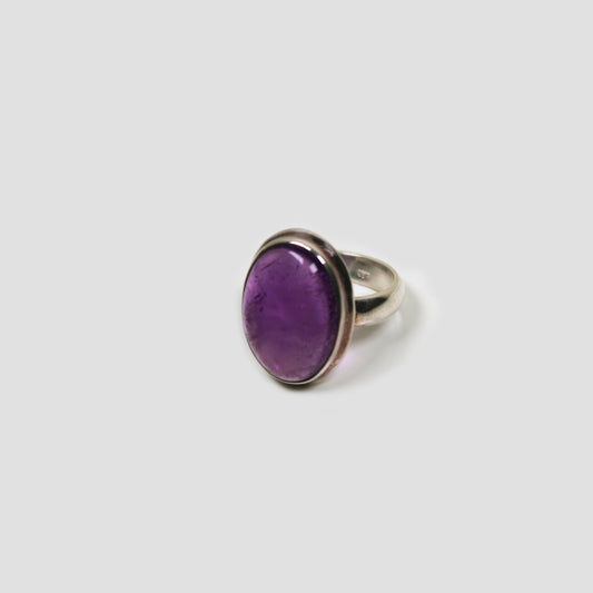 Purple Amethyst Silver Ring on a gray surface