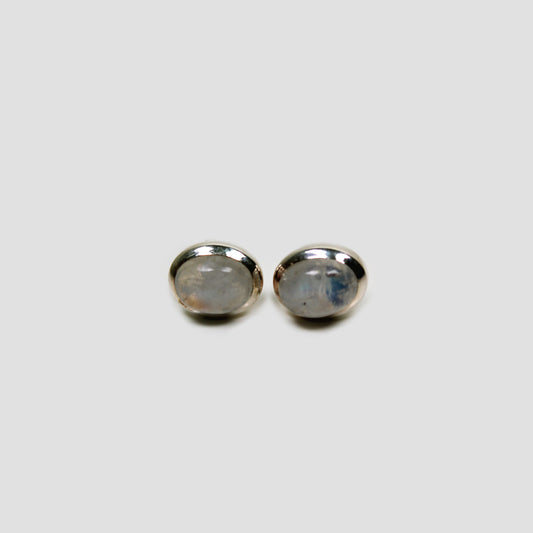 Moonstone Silver Stud Earrings on a gray surface