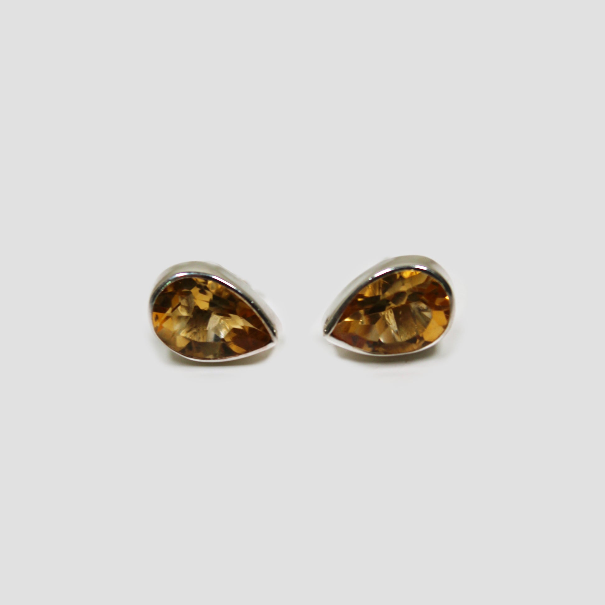 Citrine Cut Stud Earrings on a gray surface