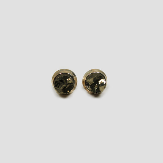 Green Pyrite Stud Earrings on a gray surface 