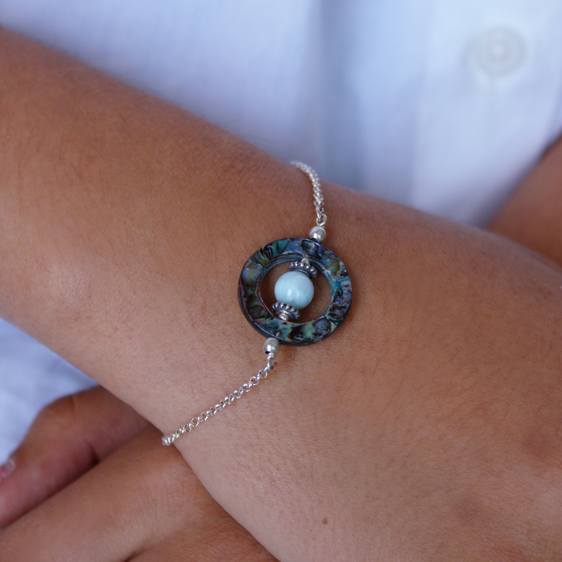 A woman wearing Larimar & Abalone Stability Bracelet