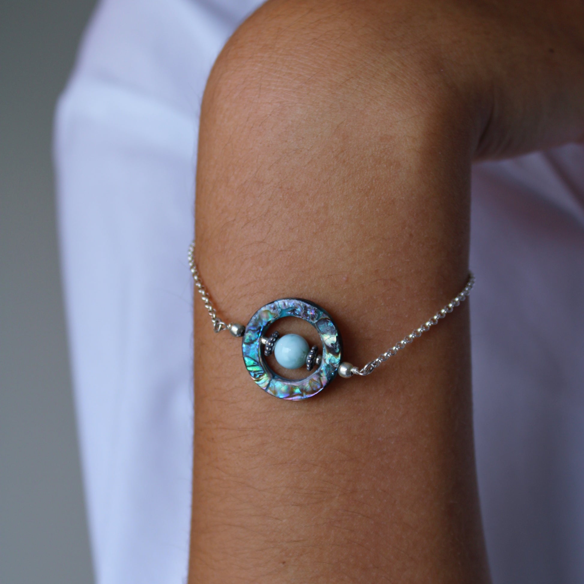 A woman wearing Larimar & Abalone Stability Bracelet 