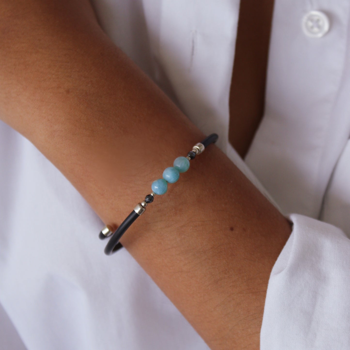 A woman wearing Larimar Leather Cord Bracelet