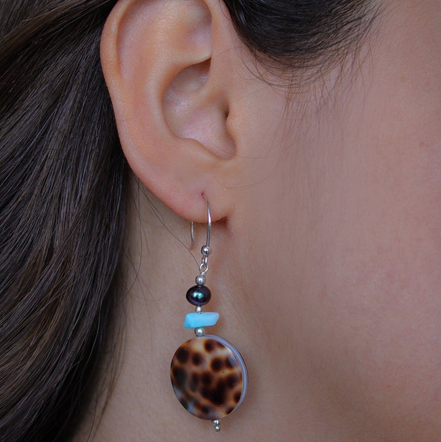 A woman wearing Larimar & Abalone Earrings