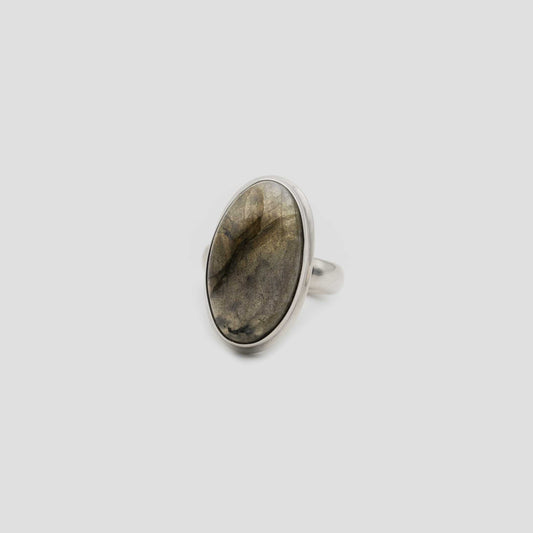 Gray Labradorite Silver Oval Ring on a gray surface