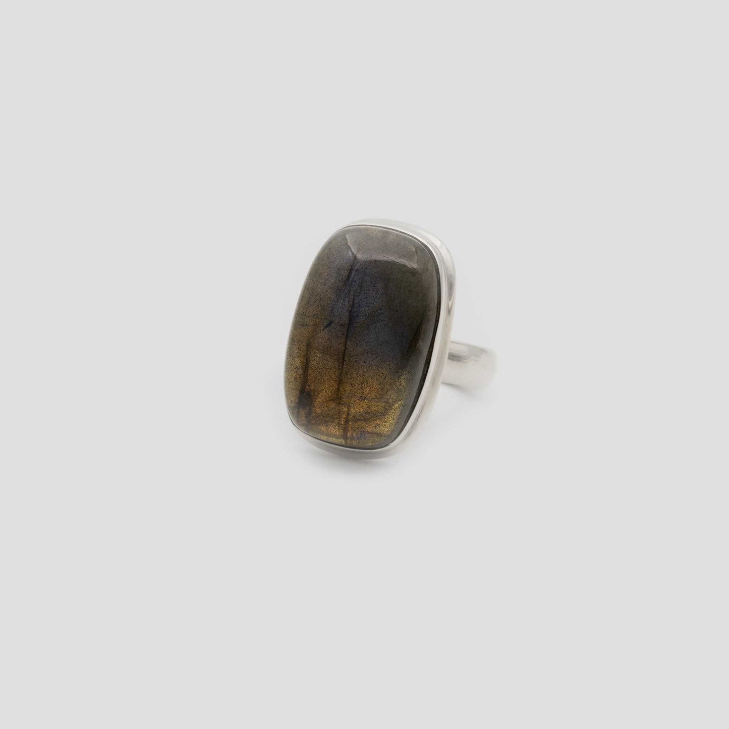 Rectangular Brown Labradorite Silver Ring on a gray surface