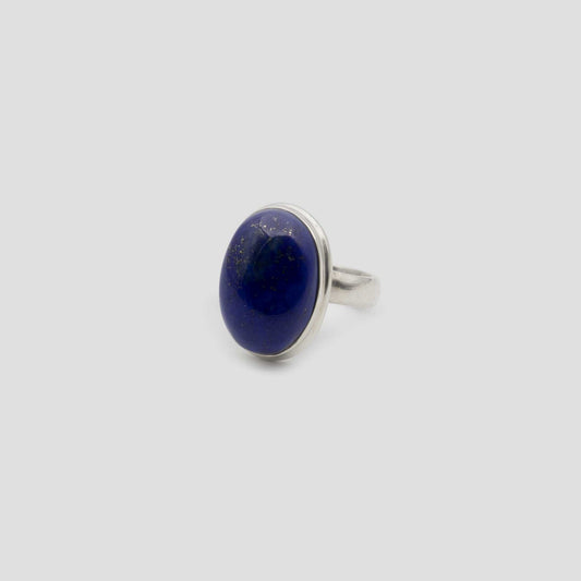 Blue Lapis Lazuli Silver Oval Ring on a gray surface