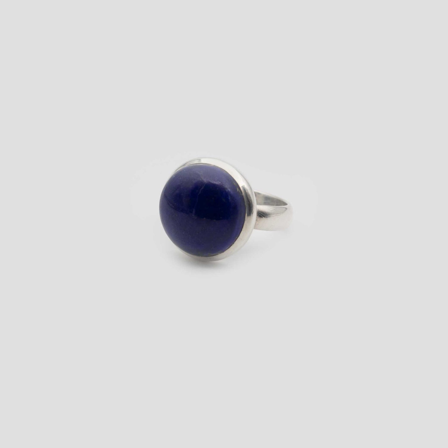 Blue Lapis Lazuli Silver Round Ring on a gray surface