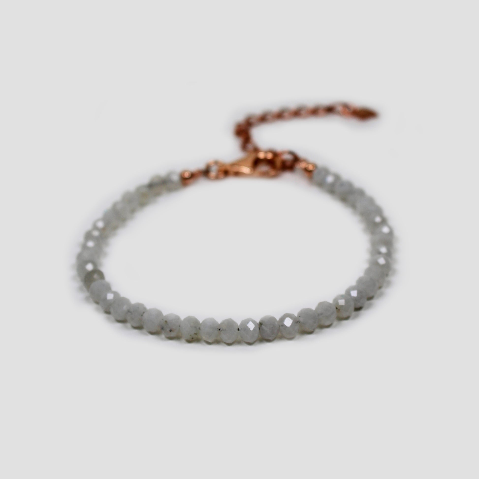 White Moonstone Faceted Bracelet on a gray surface