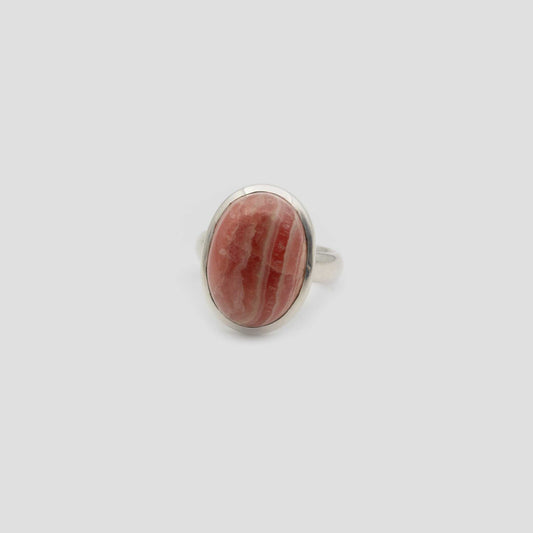 Rose Rhodochrosite Silver Oval Ring a gray surface