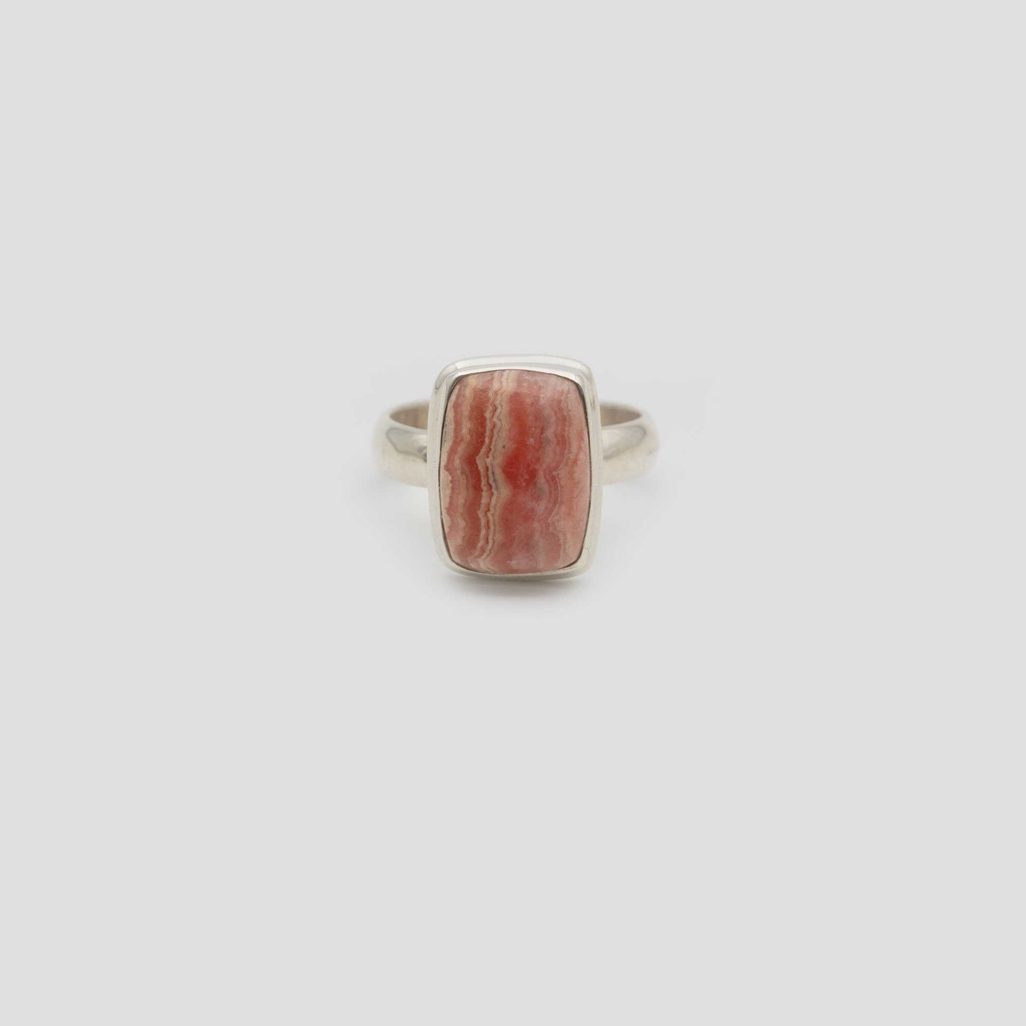 Rose Rhodochrosite Silver Square Ring a gray surface