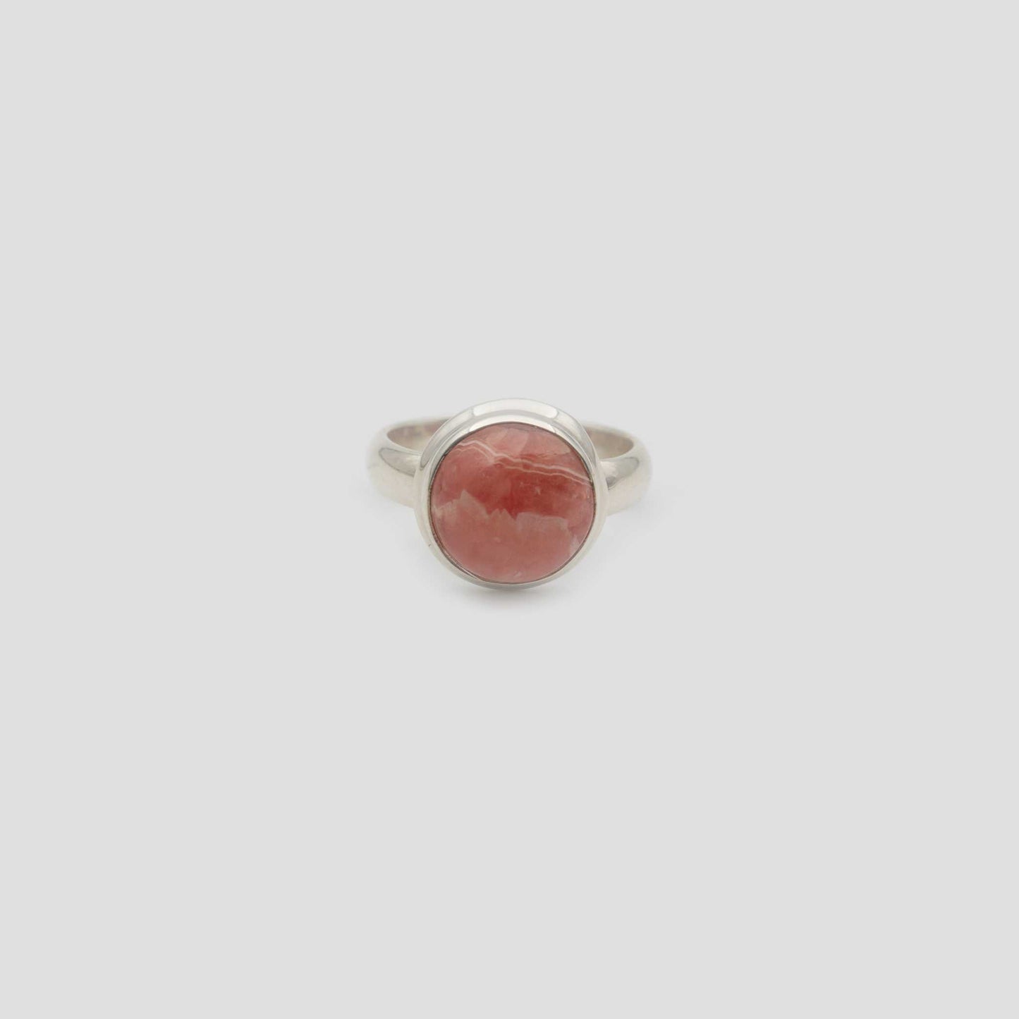 Rose Rhodochrosite Silver Round Ring a gray surface