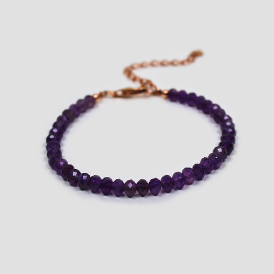 Purple Amethyst bracelet on a gray surface